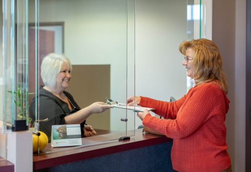 A patient at front desk registering 